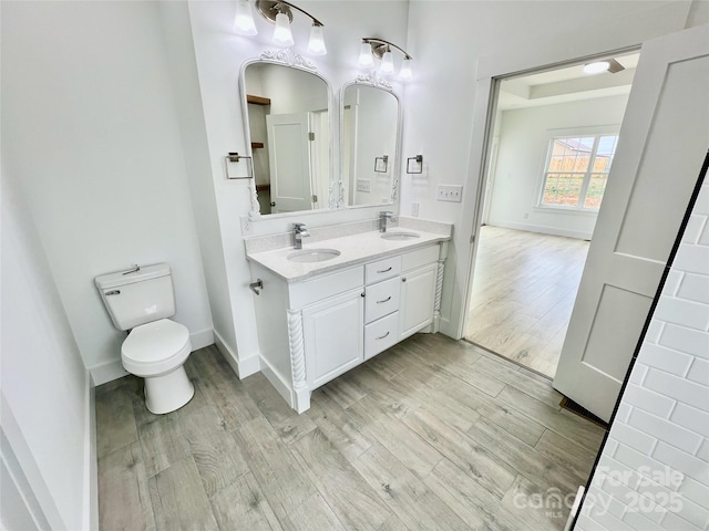 bathroom featuring vanity, hardwood / wood-style flooring, and toilet