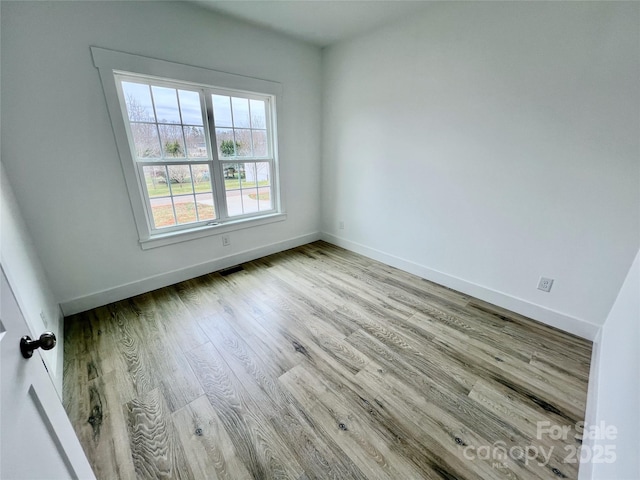 empty room with light hardwood / wood-style floors