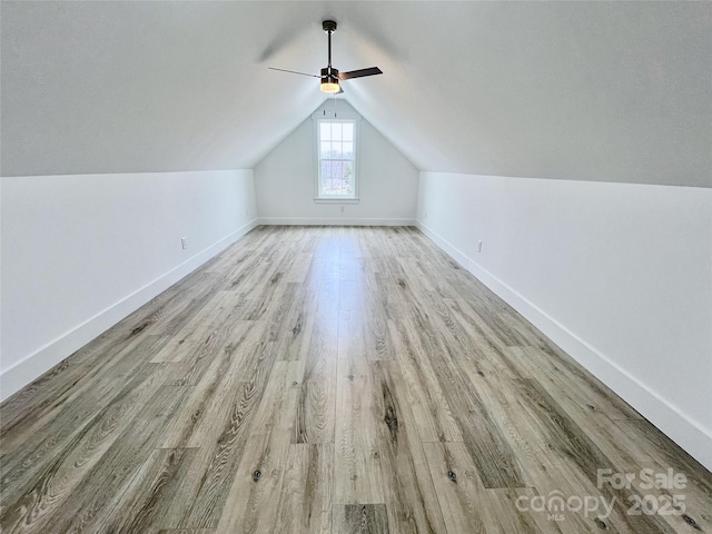 bonus room with ceiling fan, vaulted ceiling, and light wood-type flooring