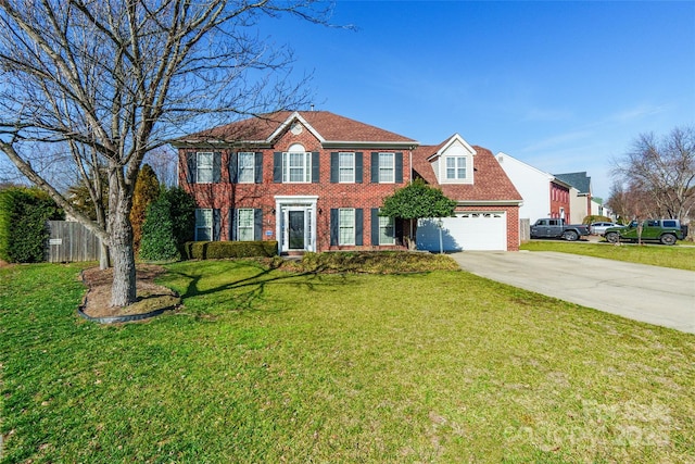 colonial-style house featuring a garage and a front yard