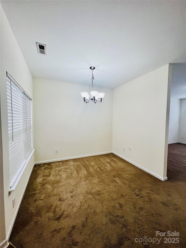 unfurnished dining area with baseboards, visible vents, dark carpet, and a notable chandelier