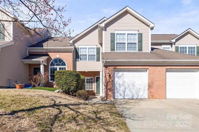 view of front of property with a front yard, brick siding, and driveway