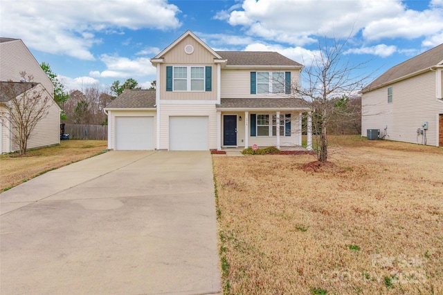 view of front of property featuring cooling unit, a garage, and a front lawn