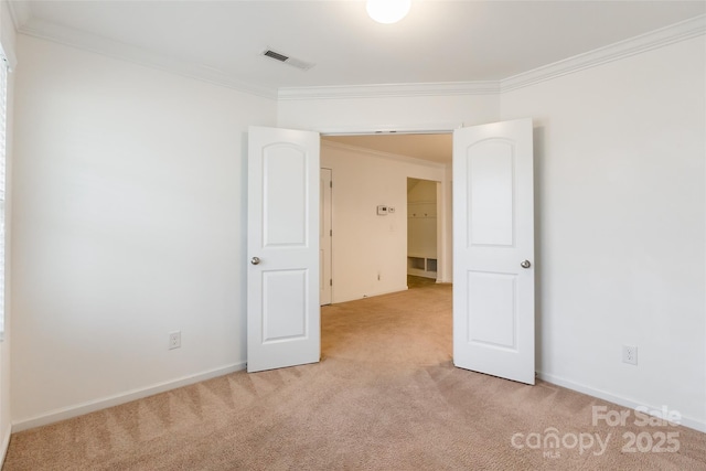 carpeted empty room featuring crown molding