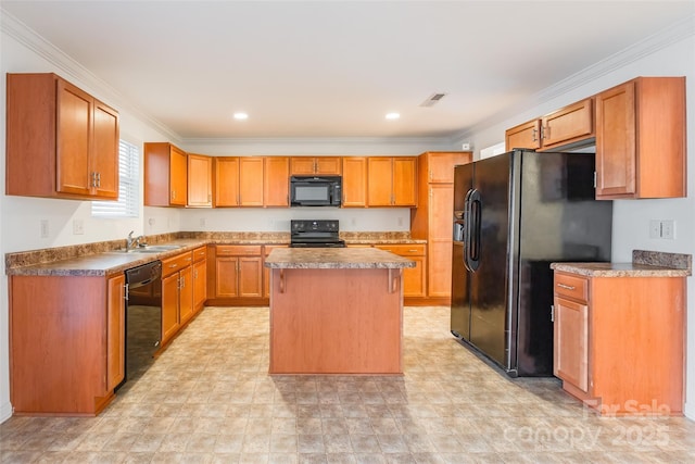 kitchen with crown molding, a center island, sink, and black appliances