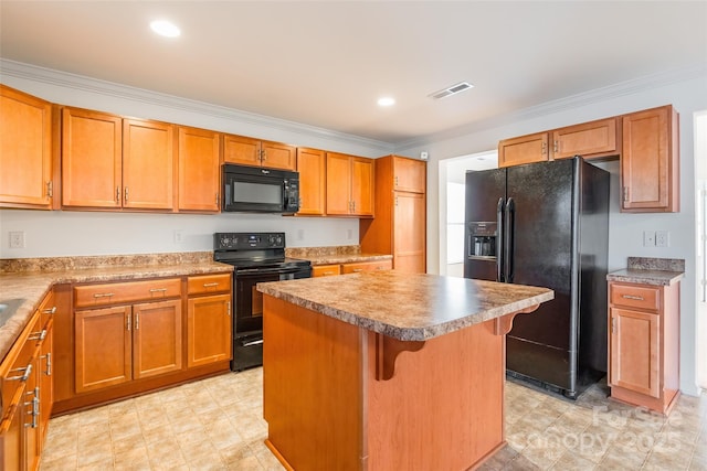 kitchen featuring crown molding, a breakfast bar, a kitchen island, and black appliances