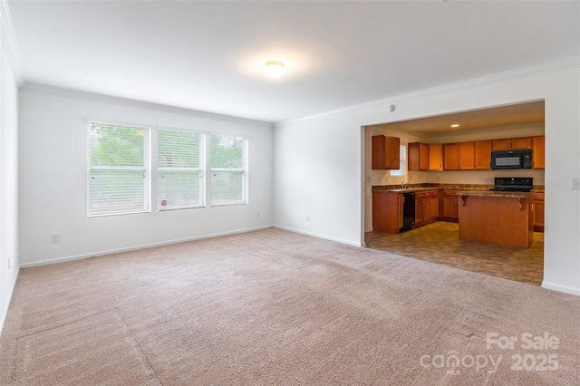 unfurnished living room featuring ornamental molding, sink, and light carpet