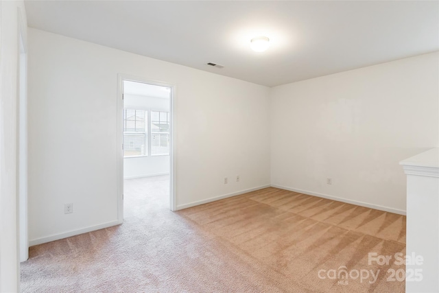 unfurnished room with light carpet