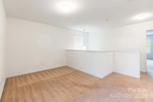 unfurnished room with light carpet