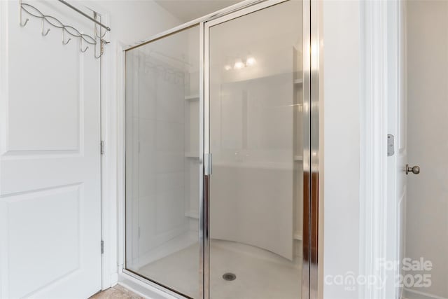 bathroom with a shower with door