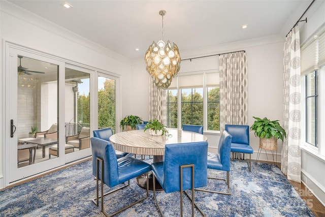 dining room featuring recessed lighting, crown molding, baseboards, and an inviting chandelier