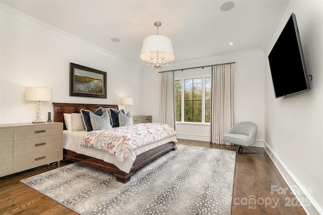 bedroom with dark wood finished floors, crown molding, and baseboards