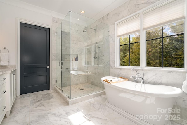 full bathroom with a stall shower, a soaking tub, marble finish floor, tile walls, and recessed lighting