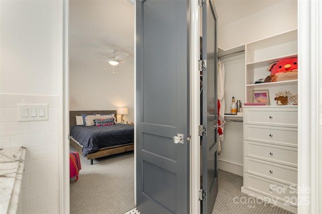 bedroom featuring carpet flooring and tile walls