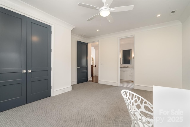 unfurnished bedroom with baseboards, carpet floors, visible vents, and crown molding