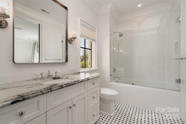 full bathroom featuring visible vents, toilet, tile patterned flooring, tiled shower / bath, and vanity