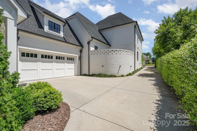 1328 S Kings Dr, Charlotte, NC 28207 - view of property exterior featuring driveway, a shingled roof, and a garage