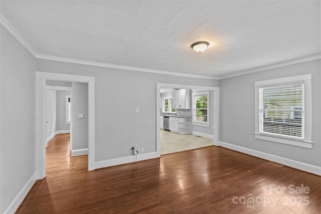 empty room with hardwood / wood-style flooring and ornamental molding