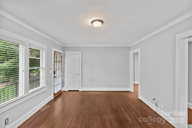 unfurnished room featuring ornamental molding and dark hardwood / wood-style floors