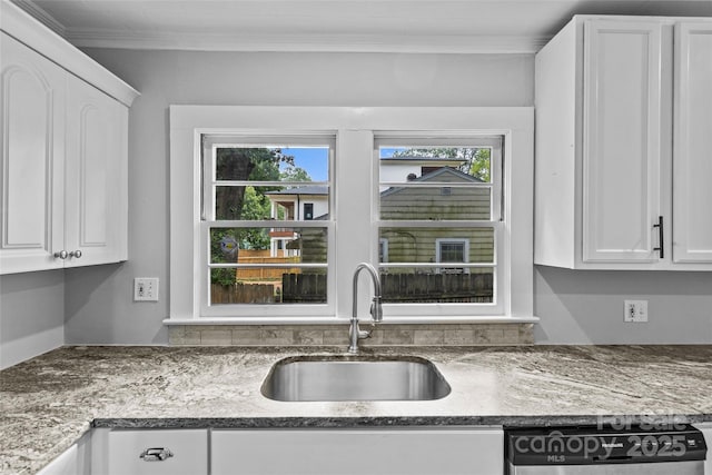 kitchen featuring crown molding, sink, stainless steel dishwasher, and white cabinets