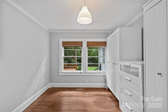 spare room featuring ornamental molding and wood-type flooring