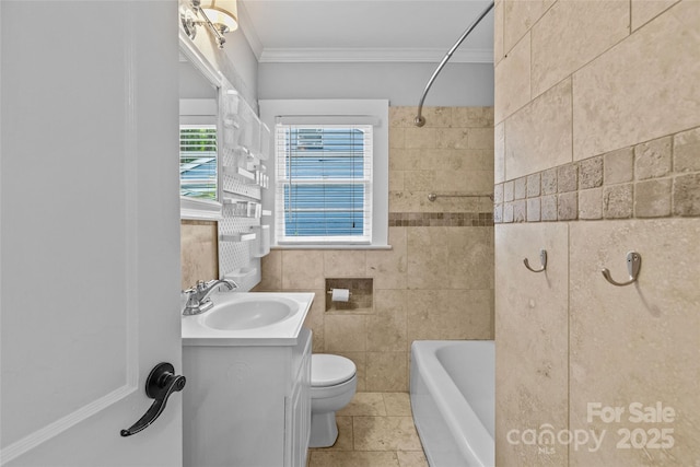 full bathroom featuring toilet, bathing tub / shower combination, tile walls, ornamental molding, and vanity