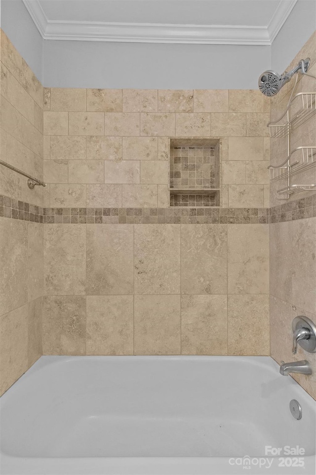 bathroom with tiled shower / bath combo and ornamental molding