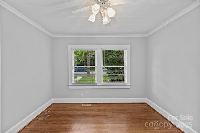 empty room featuring hardwood / wood-style floors, ornamental molding, and ceiling fan