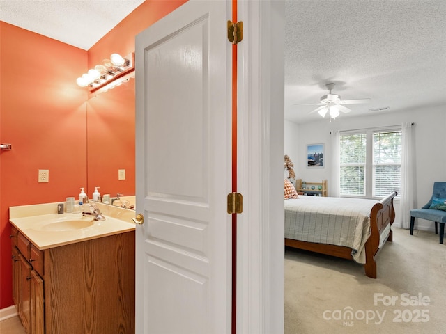 1206 Deermouse Way, Hendersonville, NC 28792 - carpeted bedroom featuring ceiling fan, sink, and a textured ceiling