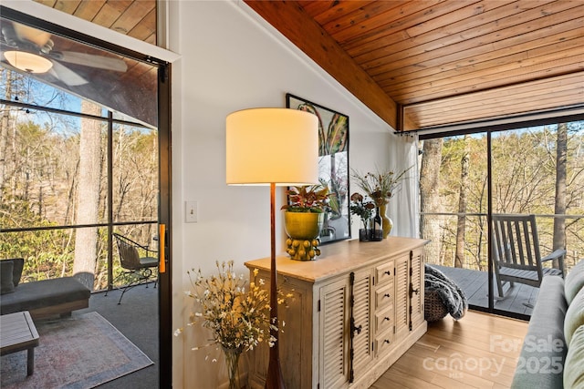 sunroom featuring a healthy amount of sunlight and wooden ceiling