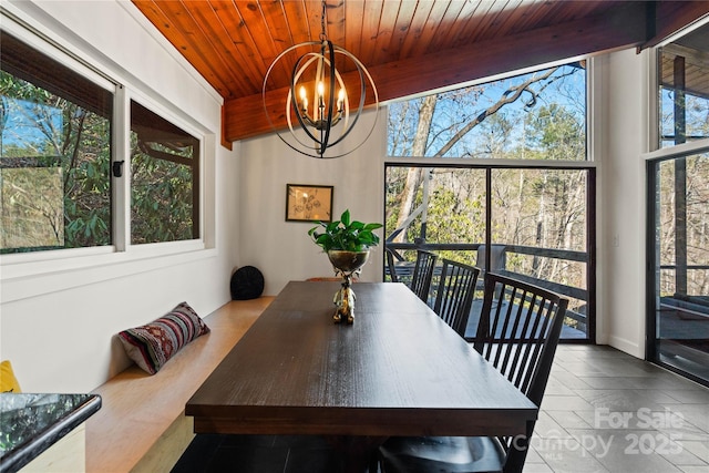 dining space featuring wood ceiling and a chandelier