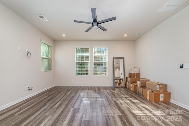 empty room with hardwood / wood-style flooring and ceiling fan