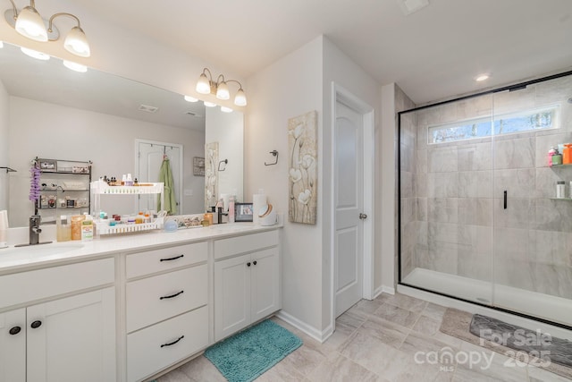 bathroom with vanity and a shower with shower door