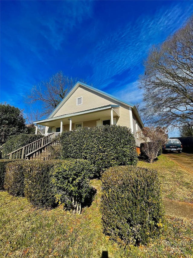 view of property exterior featuring covered porch