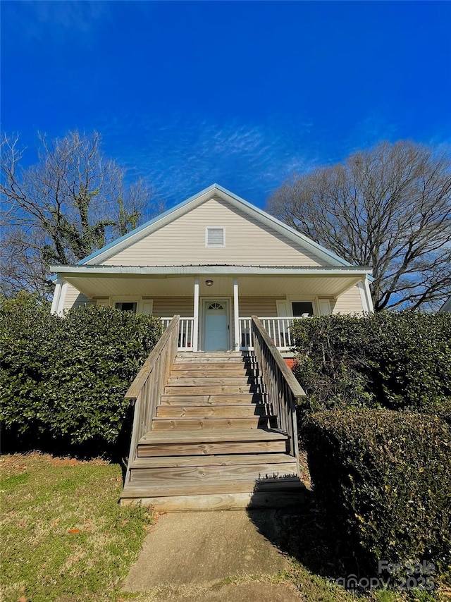 view of front of property featuring a porch and stairway