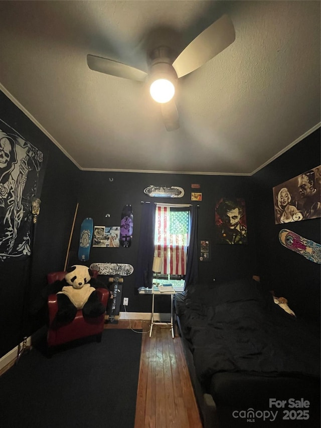 bedroom with a textured ceiling, wood-type flooring, a ceiling fan, and crown molding