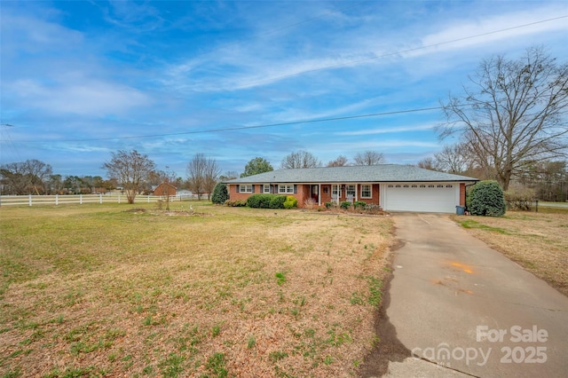 ranch-style house with a garage and a front yard