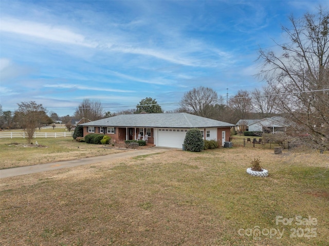 ranch-style house featuring a garage and a front yard