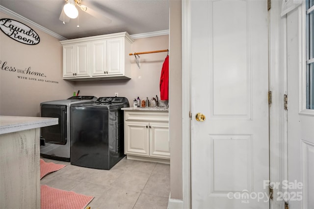 laundry room featuring sink, cabinets, ornamental molding, light tile patterned flooring, and separate washer and dryer