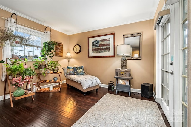 sitting room with ornamental molding and dark hardwood / wood-style floors