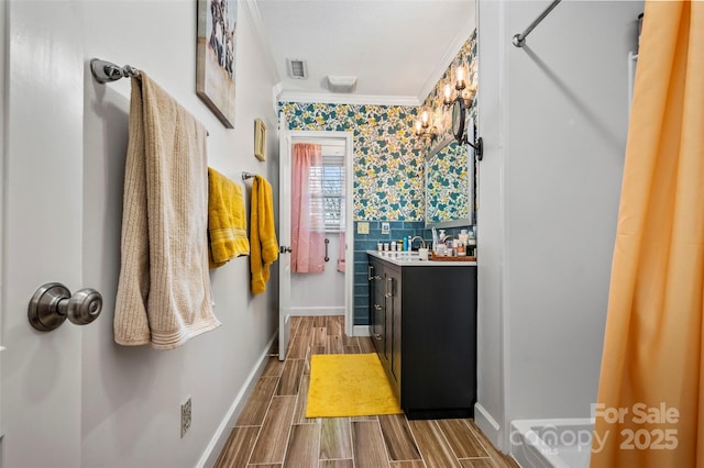 bathroom featuring crown molding and vanity