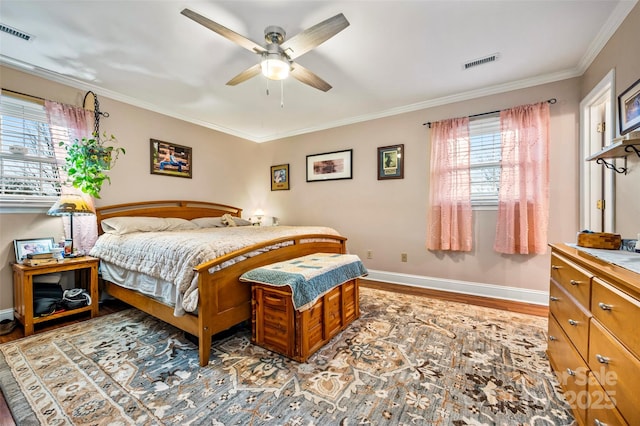 bedroom featuring ceiling fan, ornamental molding, and light hardwood / wood-style floors