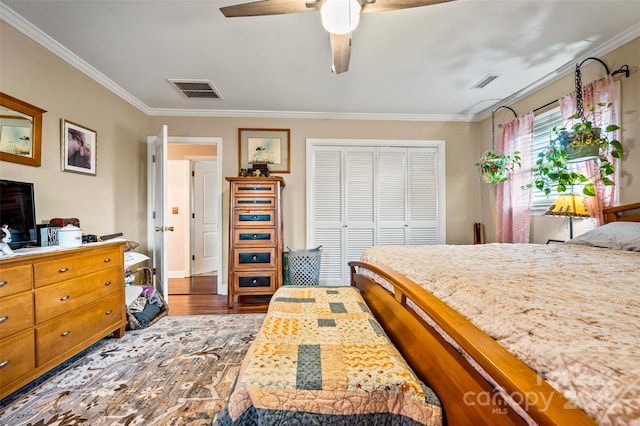 bedroom featuring ornamental molding, dark wood-type flooring, ceiling fan, and a closet