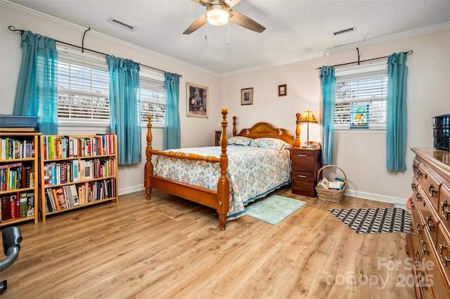 bedroom with crown molding, ceiling fan, and light hardwood / wood-style floors