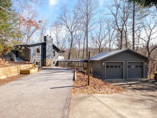 exterior space featuring a garage and a chimney