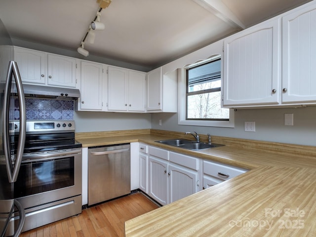 kitchen featuring white cabinetry, stainless steel appliances, and a sink