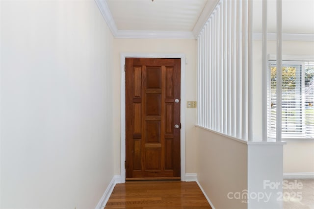 doorway to outside featuring hardwood / wood-style floors, crown molding, and a wealth of natural light