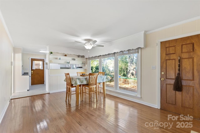 dining room featuring ornamental molding, ceiling fan, and light wood-type flooring