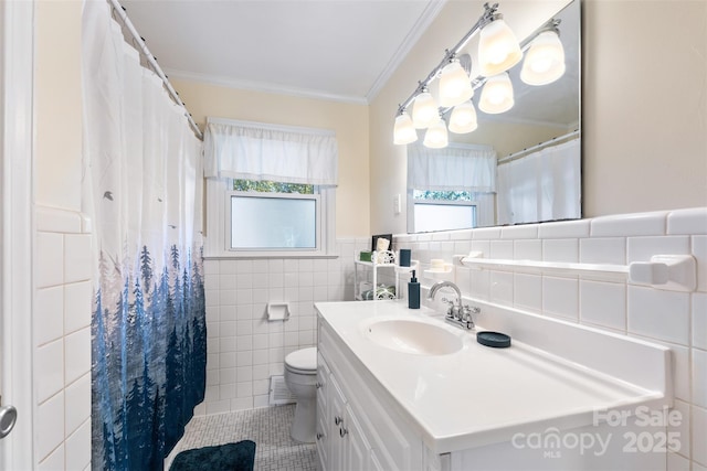 bathroom with crown molding, a healthy amount of sunlight, toilet, and tile walls