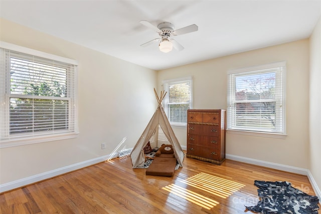 game room featuring ceiling fan and light wood-type flooring